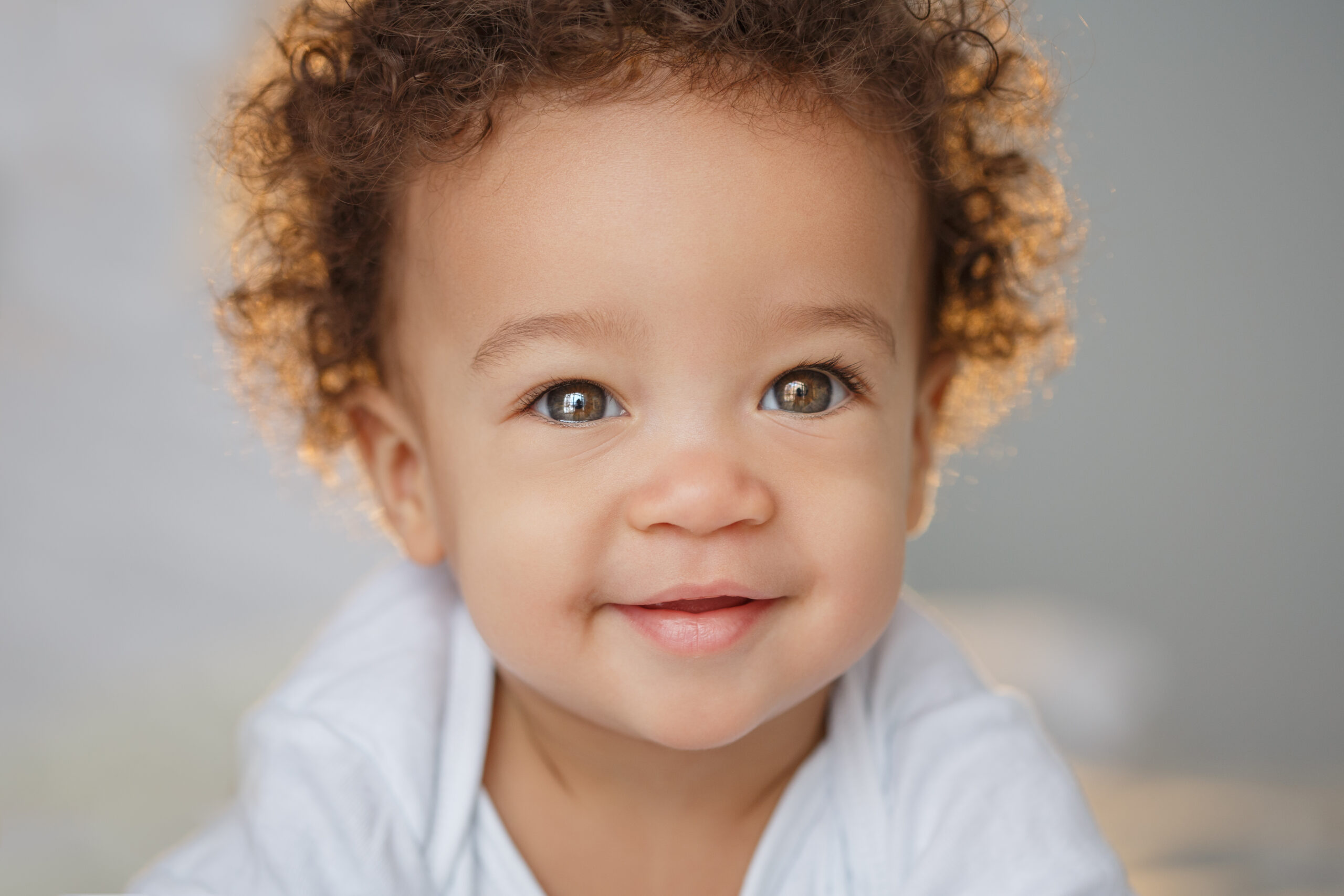 Headshot of baby with curly hair